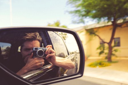 man taking car mirror shot photo