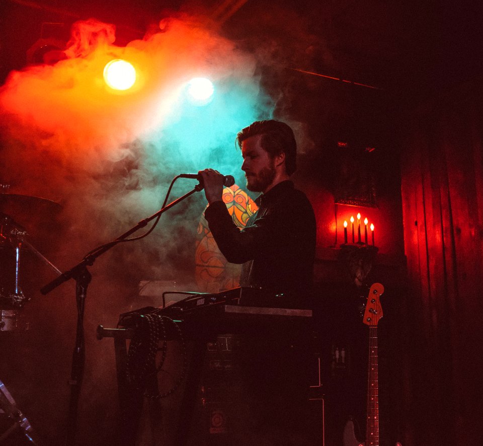 man singing on stage