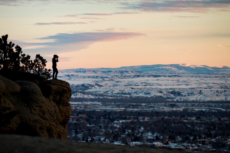 person standing on rock formation