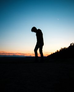 silhouette of man bowing down photo