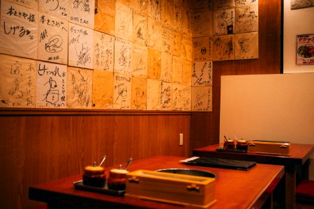 brown wooden table beside wall