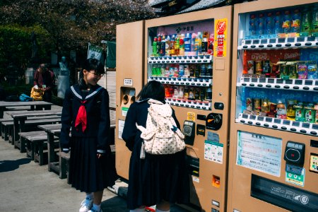 unknown person standing beside vending machine photo