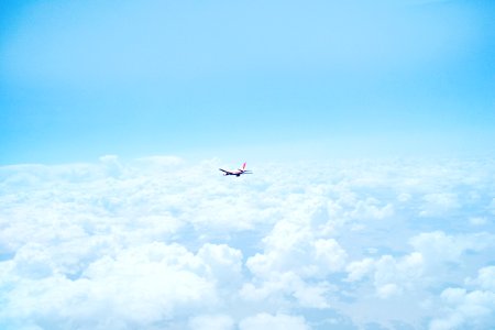 flying airplane above clouds photo