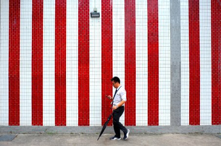 man standing near wall photo