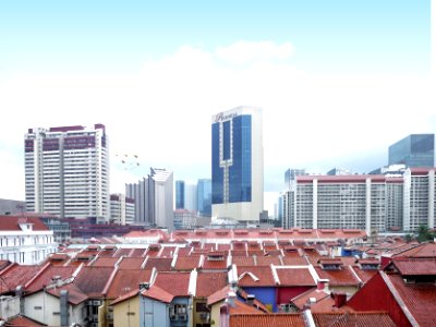 top view of house roofs and high-rise buildings under white sky photo