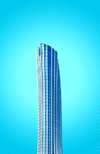 curtain-wall high-rise building under blue sky