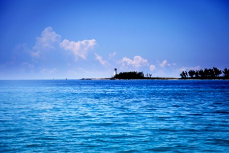 lighthouse under cumulus clouds photo