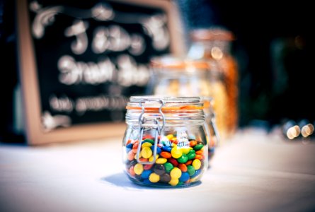 round candies in clear glass jar with clamp lid photo