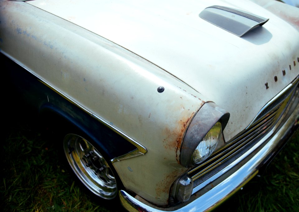 vintage white car on green grass during daytime