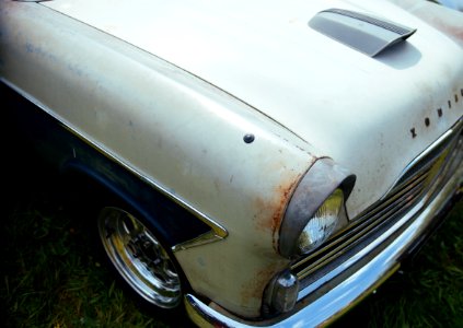 vintage white car on green grass during daytime