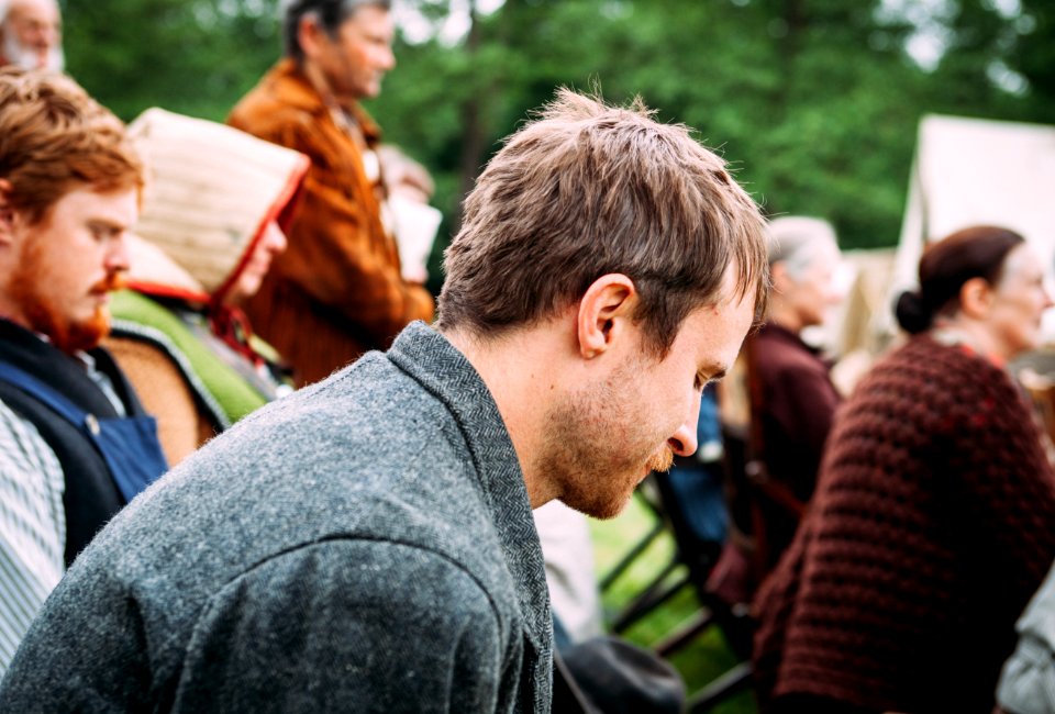 man sitting on chair near people sitting on chair during daytime photo