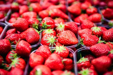 selective focus photo of strawberries in clear plastic containers photo