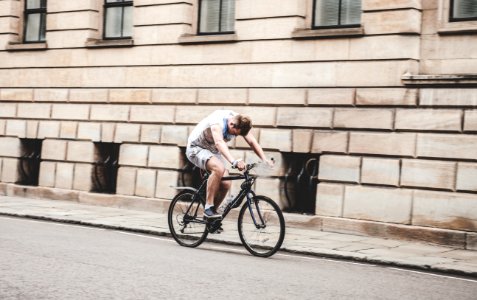man wearing gray t-shirt and gray shorts cycling photo