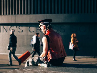 man sitting on pavement photo