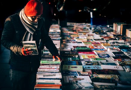 man picking up book ob book sale