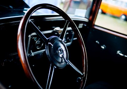 closed up photo of brown and black vehicle steering wheel photo