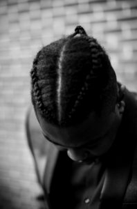 man showing braided hairstyle photo