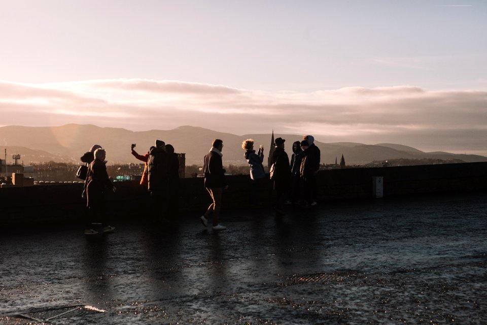 people standing on rooftop during daytime photo