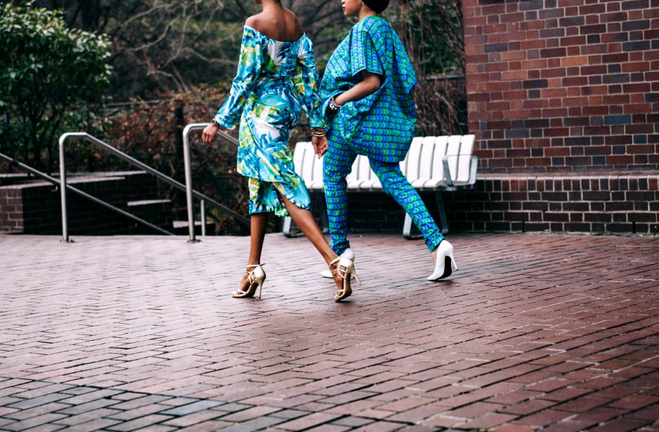 two women in teal romper pants