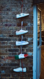 five white sneakers hanged near white door photo