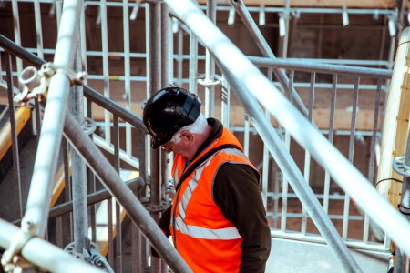 man standing under scaffoldings