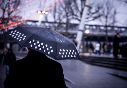 person holding black umbrella photo