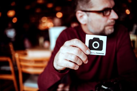 man walking a card with camera icon photo