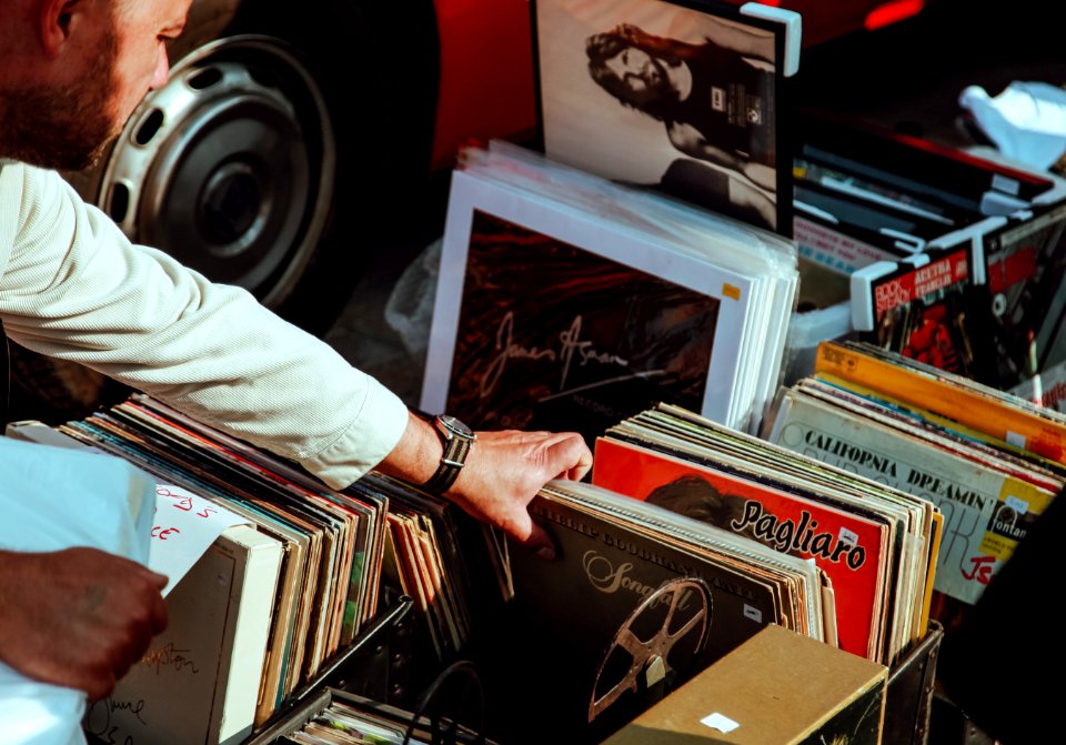 person holding vinyl records