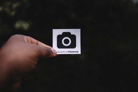 person holding white paper showing camera illustration photo