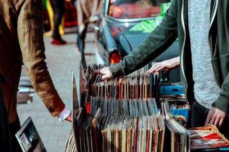person selling vinyl album in street photo