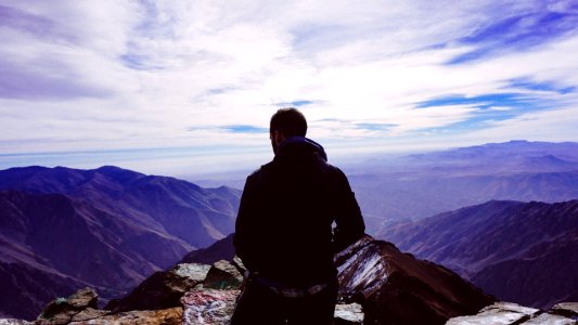 man standing on mountain during daytime photo