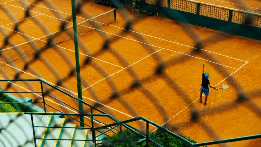 man playing tennis in court photo