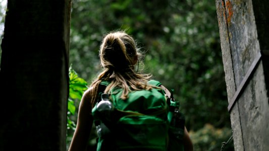 person wearing green backpack photo