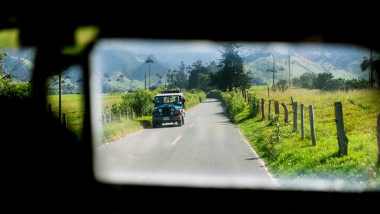 reflect view on blue SUV near grass photo