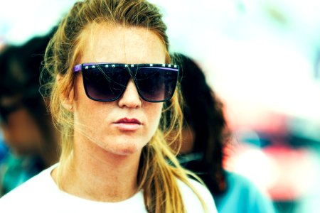 shallow focus photography of a woman wearing over sized sunglasses photo