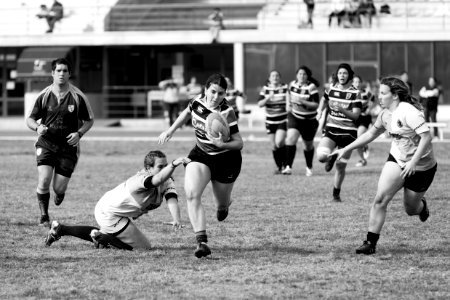 grayscale photo of women playing rugby football photo
