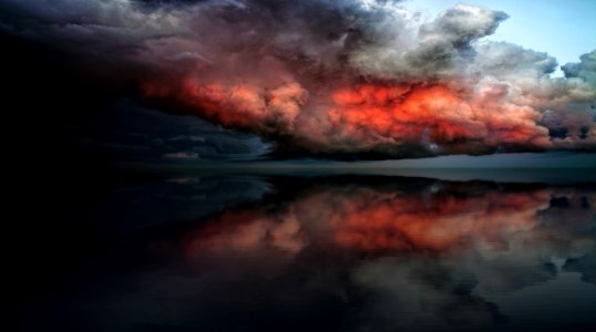 body of water under red and white clouds photo