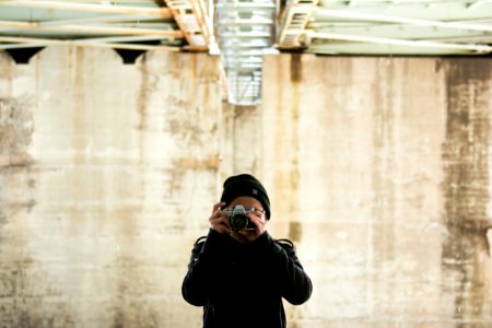 person in jacket holding jacket during daytime photo