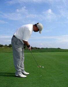 Men putting blue golf