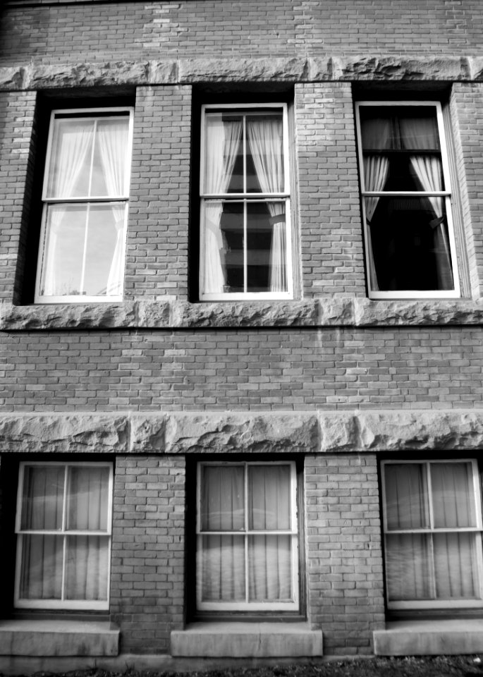grayscale photography of brick building photo