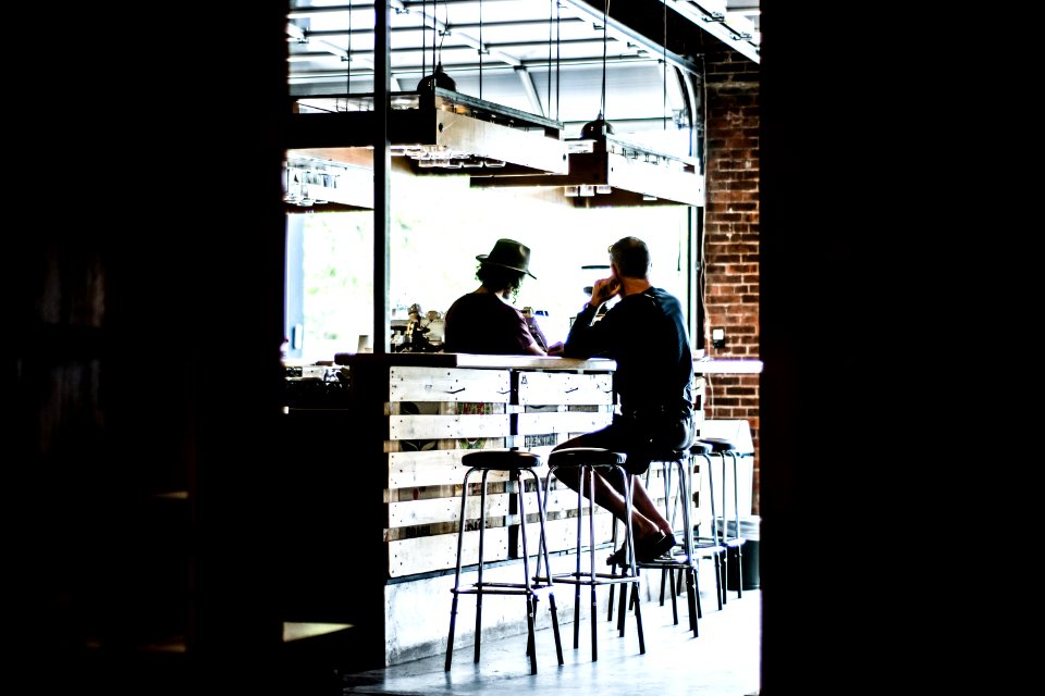 man sitting on bar stool