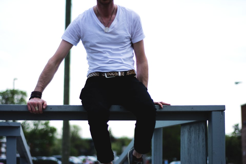 man sitting on balustrade