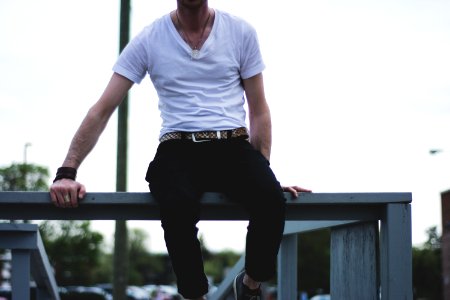 man sitting on balustrade