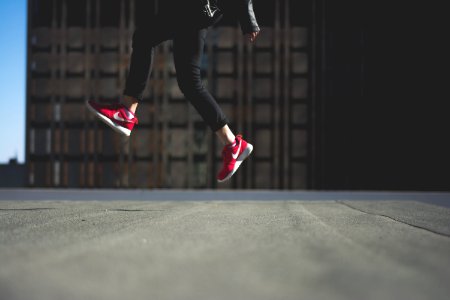 person wearing pair of red Nike shoes photo
