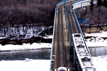 train crossing bridge during daytime photo