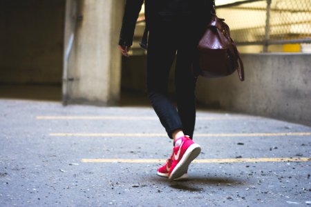 person wearing Nike running shoes walking along the path photo