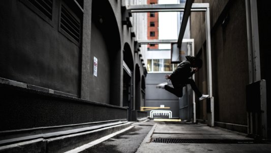person wearing black pants and white shoes jumpshot
