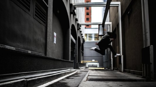 person wearing black pants and white shoes jumpshot photo