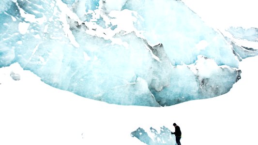 person standing on snow field near mountain photo