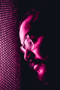 person with eyeglasses leaning his head on screen